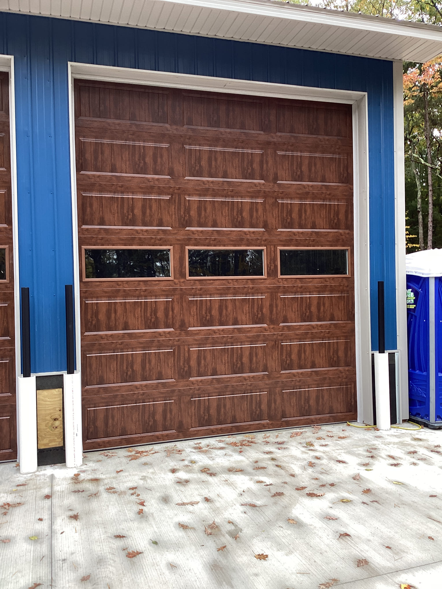 Wood-look commercial overhead door installed by Precise Door Co.